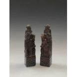 A pair of Chinese soapstone bookends, early 20th century, carved with dowest figure and attendant,