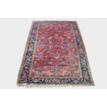 A Heriz carpet, North West Persia, the madder field with an all over design of palmettes , flowering