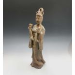 A Chinese earthenware figure of Guanyin, with a goblet in each hand, height 53cm.