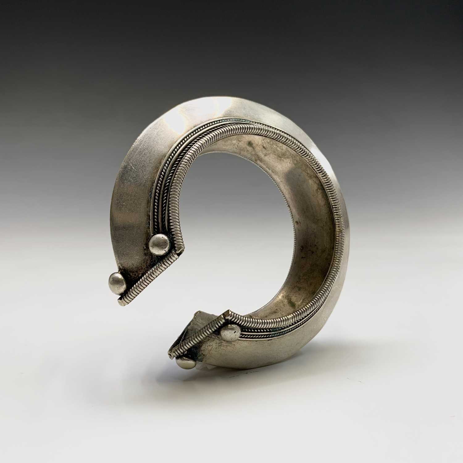 Two silver tribal bangles and a brass cuff, Laos.Condition report: the inner size of all three - Image 3 of 8