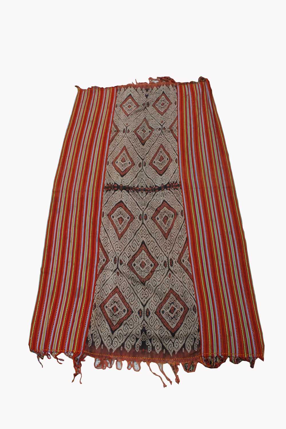 An East Timor blanket, with lozenge hooked gul motifs with polychromed striped border, 188 x 110cm.