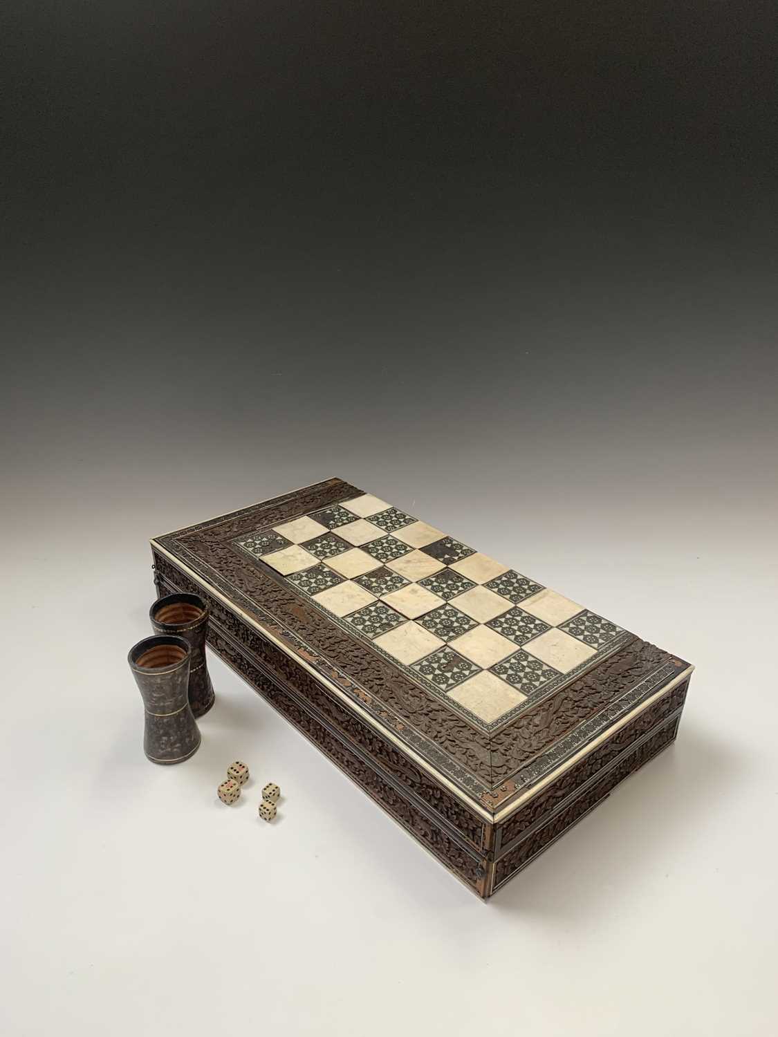 An Anglo-Indian sandalwood games board, 19th century, with ivory and sadeli chess squares within a