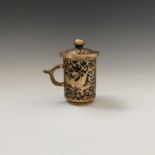 A Tang style hardstone gilded tankard and cover, with stylised birds amongst leavy tendrils,