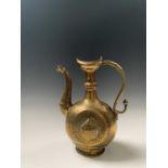 An Indian brass ewer, Deccan, 18th century, the boat shaped mouth above a narrow neck and collar,