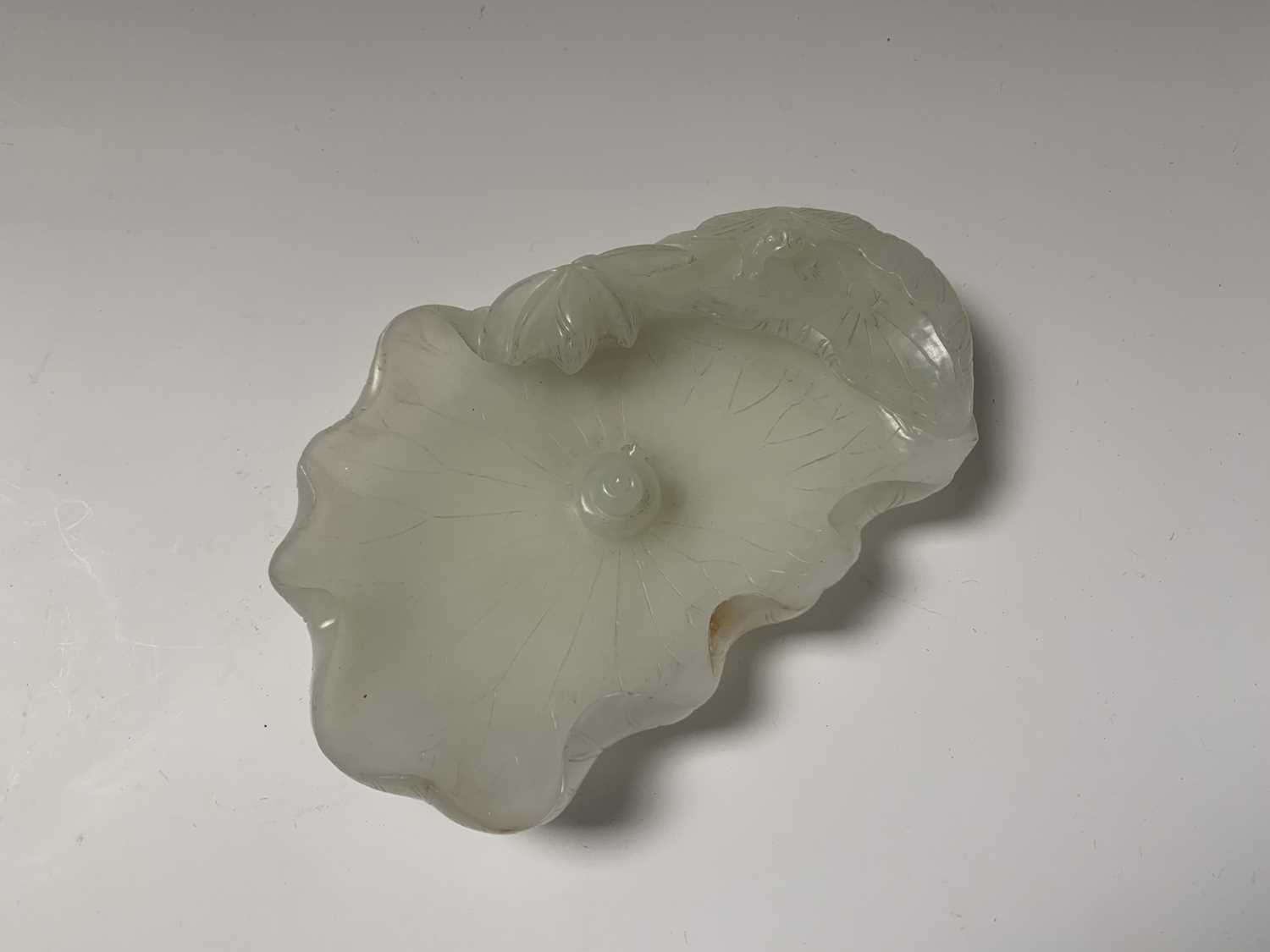 A Chinese white jade 'lotus leaf' brushwasher, 19th Century, height 2.5cm, width 13cm, depth 8.5cm. - Image 3 of 20