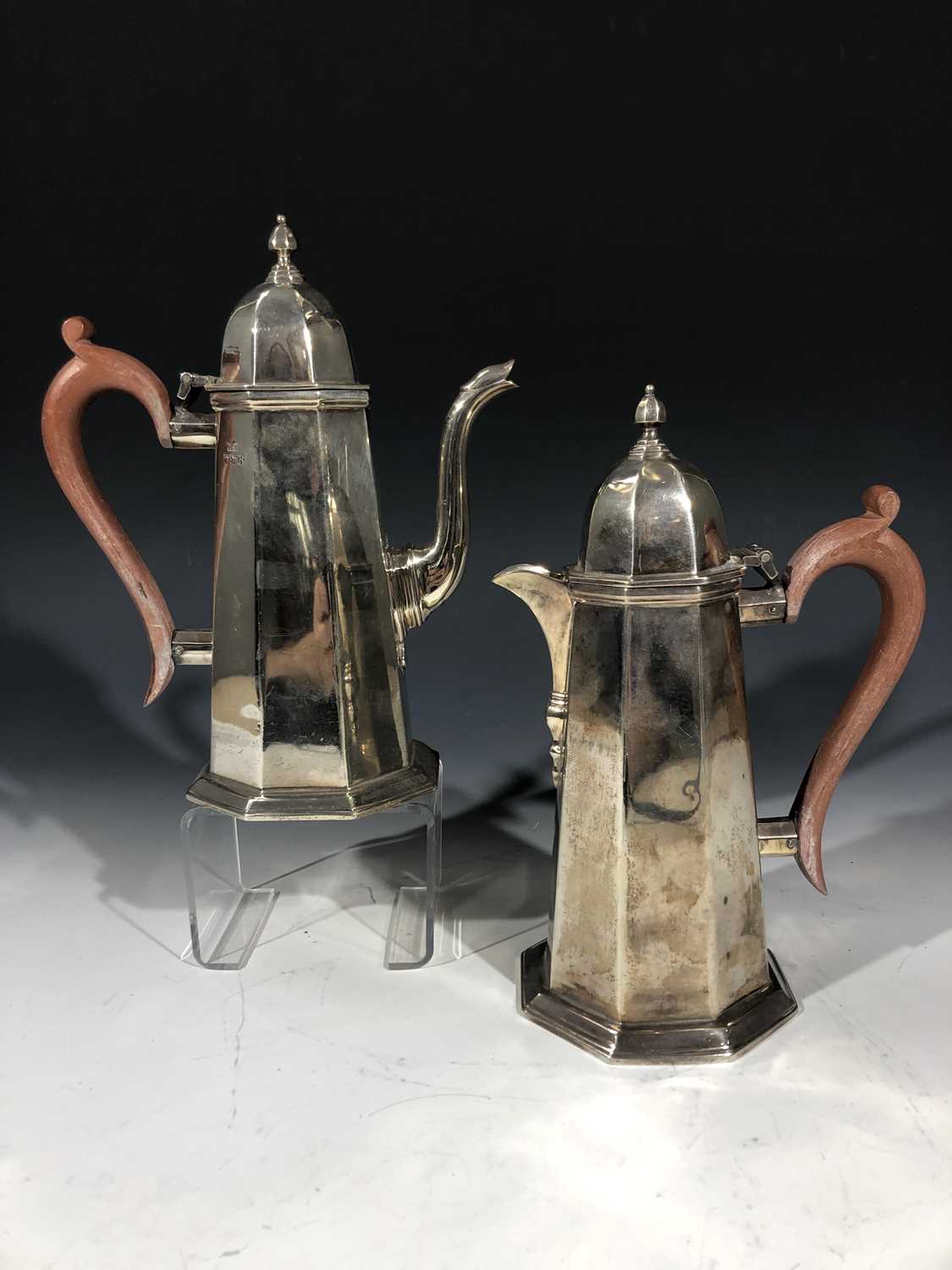 A pair of silver octagonal section pots in early 18th-century style, one for coffee the other hot