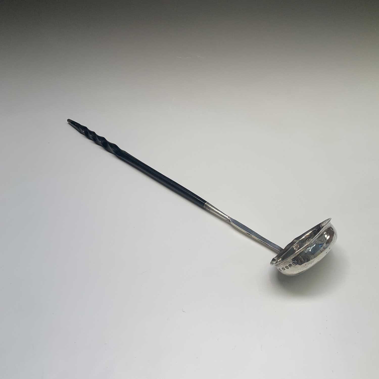 A George III silver punch ladle by Elizabeth Morley the plain oval bowl with silver tipped spiral