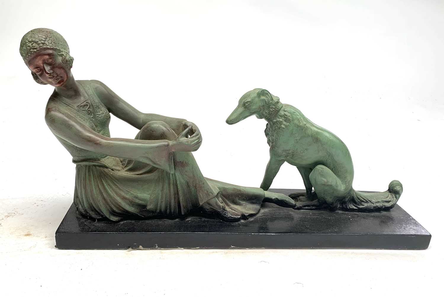 A French 1930s plaster group modeled as a seated lady beside a borzoi hound, overall length 61cm.