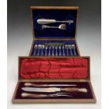 A cased three piece carving set with stag horn handles and elaborate hallmarked sillver mounts, in