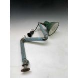 A mid century adjustable workshop lamp, with green enamelled shade, maximum length 80cm.