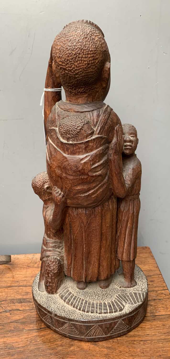 An African carved wood sculpture depicting a woman with three children. Height 39cm. - Image 2 of 3