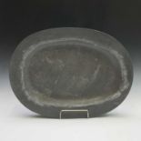 A large 19th century pewter meat platter of oval form, width 62cm.