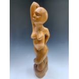 A carved wood figure of a woman. Height 73cm.