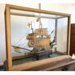 A model of The Golden Hind, Sir Francis Drake's ship, in glazed oak display case. Length of ship