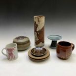 A collection of studio pottery to include a Briglin cylindrical vase with resist incised leaf