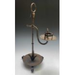 An Arts and Crafts period wrought iron candle stand. Height 60cm.