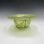 A Tiffany style iridescent green glass bowl, early 20th century, with wide striated rim and with '