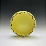 Michael Powolny, for Loetz, a yellow glass bowl with crimped, black edged rim, diameter 26cm.