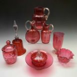 A collection of Victorian cranberry glass to include a celery vase, jugs and dishes, together with a