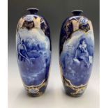 A pair of late 19th century blue and gilt vases of ovoid form, printed with bucolic scenes. Height