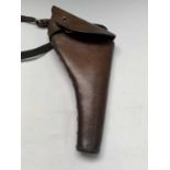 A WW2 tan leather army holster and strap, stamped PH 3/40, the holster length 35cm.