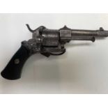 A 19th century small six shot revolver, with ornate engraved decoration, folding trigger and