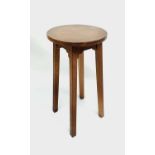 An Arts and Crafts oak stand in Cotswold style, circular top on square legs, height 79cm, diameter