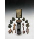 Seven assorted bronze hand bells, variously numbered, together with a small map of Glocester (SIC