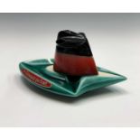 A 1960s SS.France funnel ashtray in the form of a ship, bearing label 'La Cheminee Qui Fume', in the