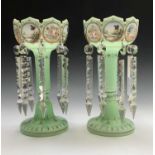 A pair of Victorian opaque green glass lustre vases, each with crenallated rims and eight floral