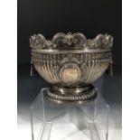 An impressive Scottish retailed silver montieth punch bowl with lions head handles, fluting and a