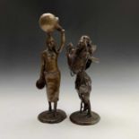 A Nigerian bronze figure of a female water carrier, on a circular base, height 36.5cm, together with