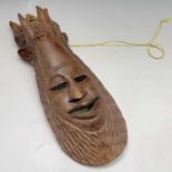 An African carved wood mask. Height 54cm.