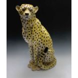 A large ceramic model of a seated leopard. Height 78cm.