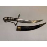 An Eastern dagger, with mother of pearl and red painted handle, engraved blade and leather and brass