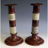 Pair of Victorian red and grey serpentine candlesticks with sectional shafts. Height 21cm.