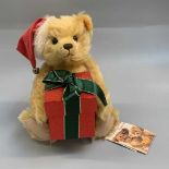 Teddy Bear - Steiff. Christmas 2007 bear holding Christmas box containing bell bauble. No