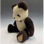 A 20th century plush panda with jointed limbs. Height 56cm.