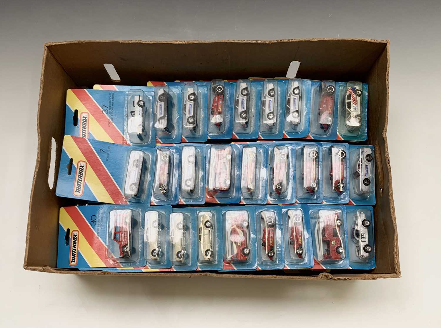Matchbox cars: Approx. 90 Matchbox 1980's bubble packs contained in a banana box -some duplication.