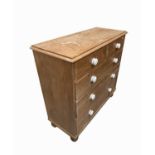 A pine chest of drawers, with two short and three long drawers, on turned bun feet, height 102cm,