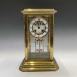 A four glass brass mantel clock, the two part white enamel dial signed J W Benson, Ludgate Hill,