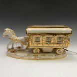 A Capo di Monte gilt porcelain illuminated horse drawn Romany caravan. Height 23.5cm, width 47cm,