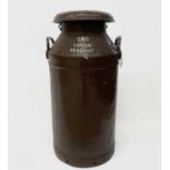 An early 20th century milk churn inscribed 'GWR LONDON PENZANCE', chocolate and cream colouring.