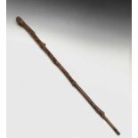 An unusual early 19th century naive walking stick, the terminal carved as a bearded man wearing a