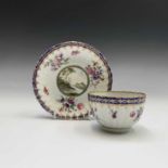 A Worcester porcelain tea bowl and saucer, circa 1775, painted in polychrome enamels with the '