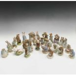 A collection of twenty-two Royal Albert Beatrix Potter figures to include 'The Old Woman who lived