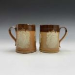 A pair of early 20th century Royal Doulton salt glaze stoneware mugs commemorating the coronation of