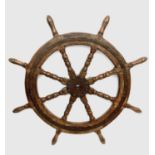A hardwood eight-spoke ship's wheel, circa 1900, with iron mounts. Diameter 102cm.