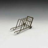 An unusual EPNS toast or letter rack, shaped as a porter's trolly. length 16cm.