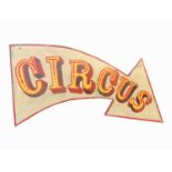 A sign written wooden sign in the shape of an arrow 'CIRCUS'. 67 x 115cm (irregular).